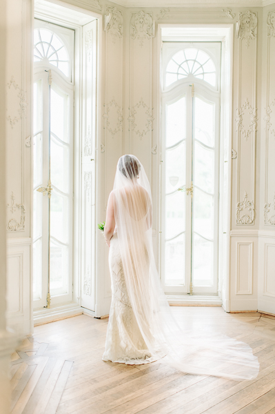 Bride standing in her veil.