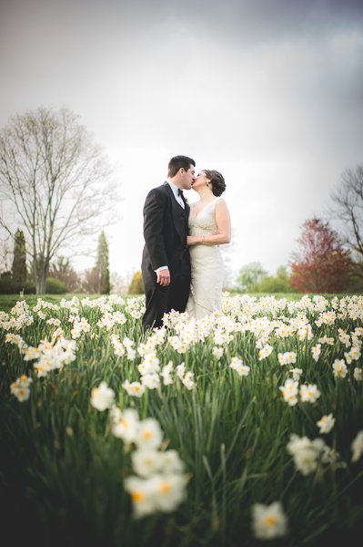 Bride and Groom kissing in a field of tulips.