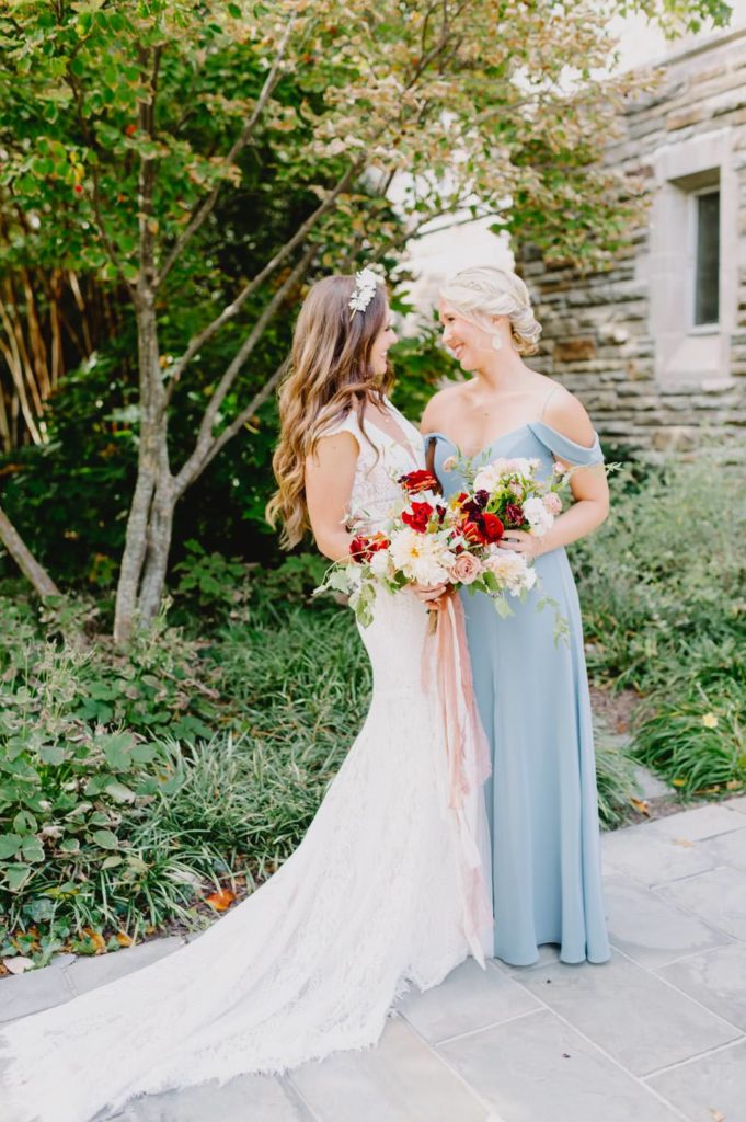 The bride and her maid of honor share a light-hearted laugh, capturing the essence of their close bond. L Hewitt Photography

