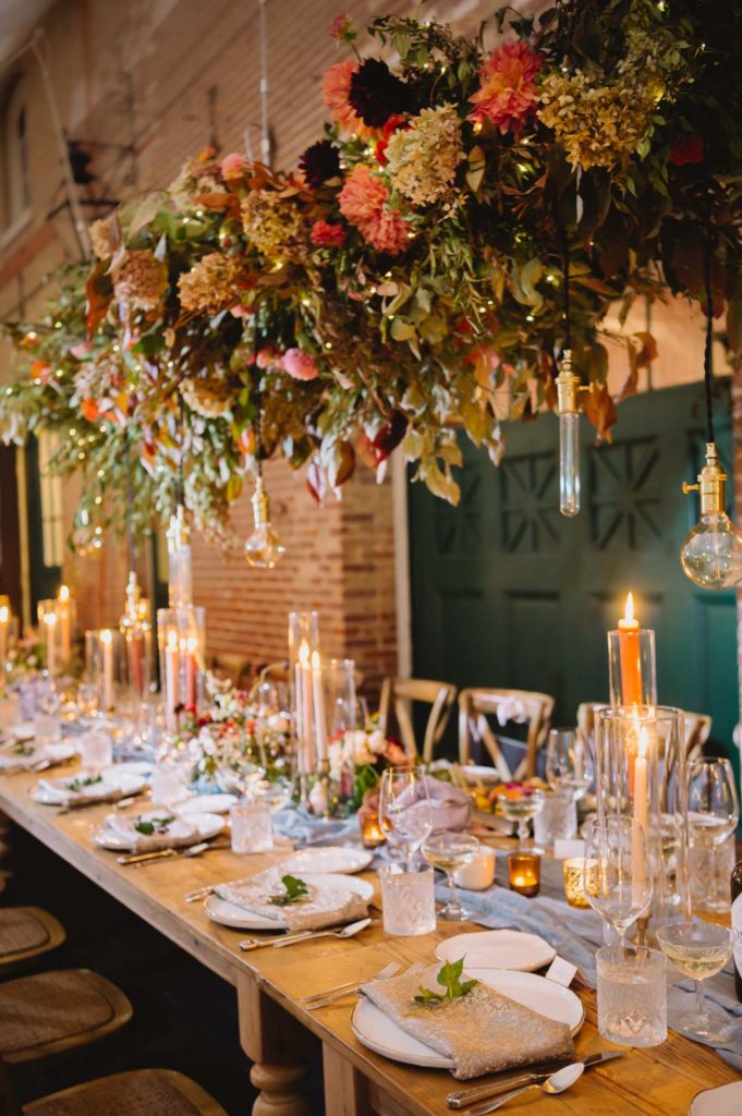 The enchanting garden-style wedding reception is further enhanced by gorgeous glassware, adding a touch of sophistication. L Hewitt Photography

