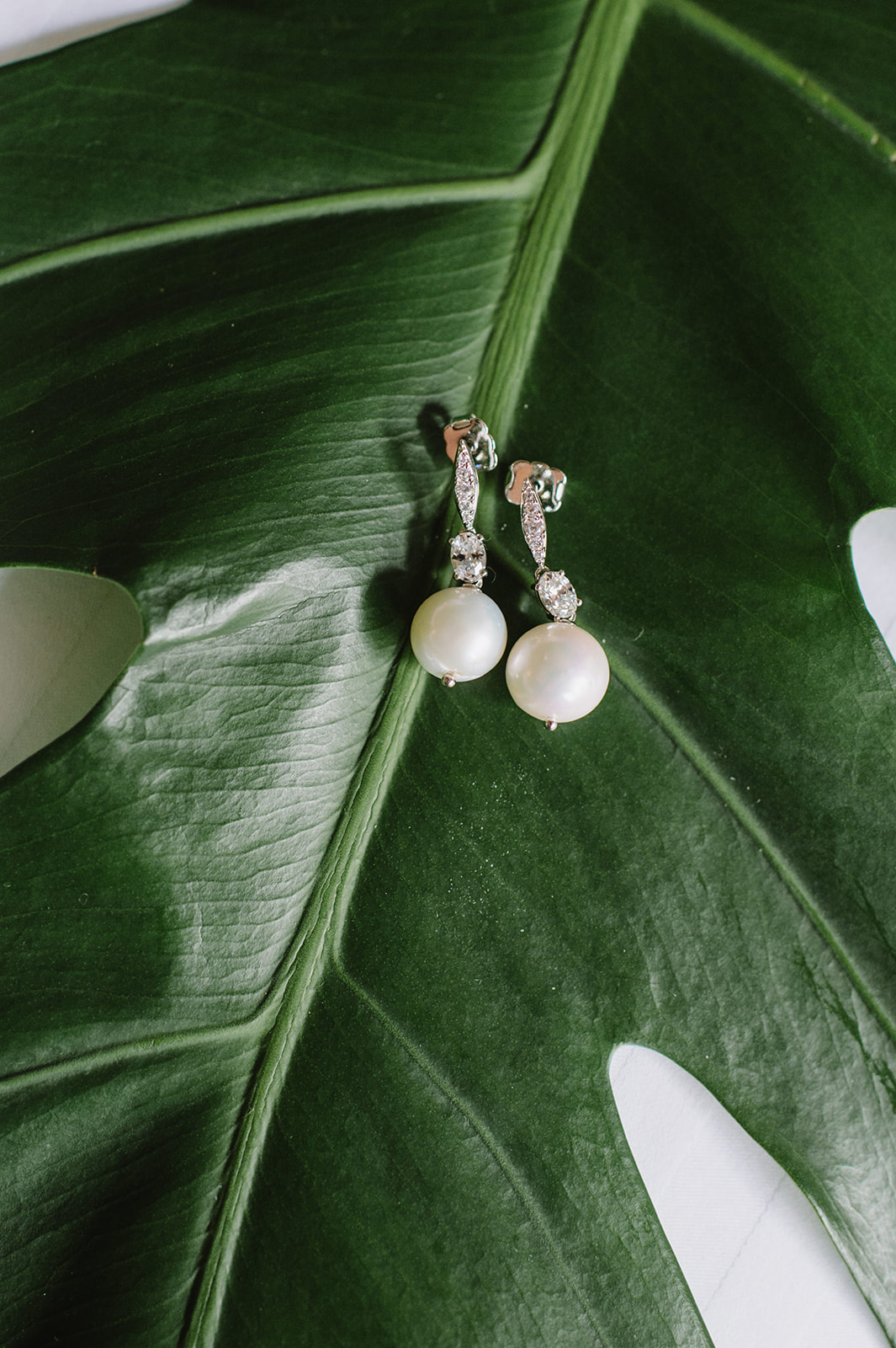 Elegant pearl earrings with leaves from Kualoa Ranch L Hewitt Photography