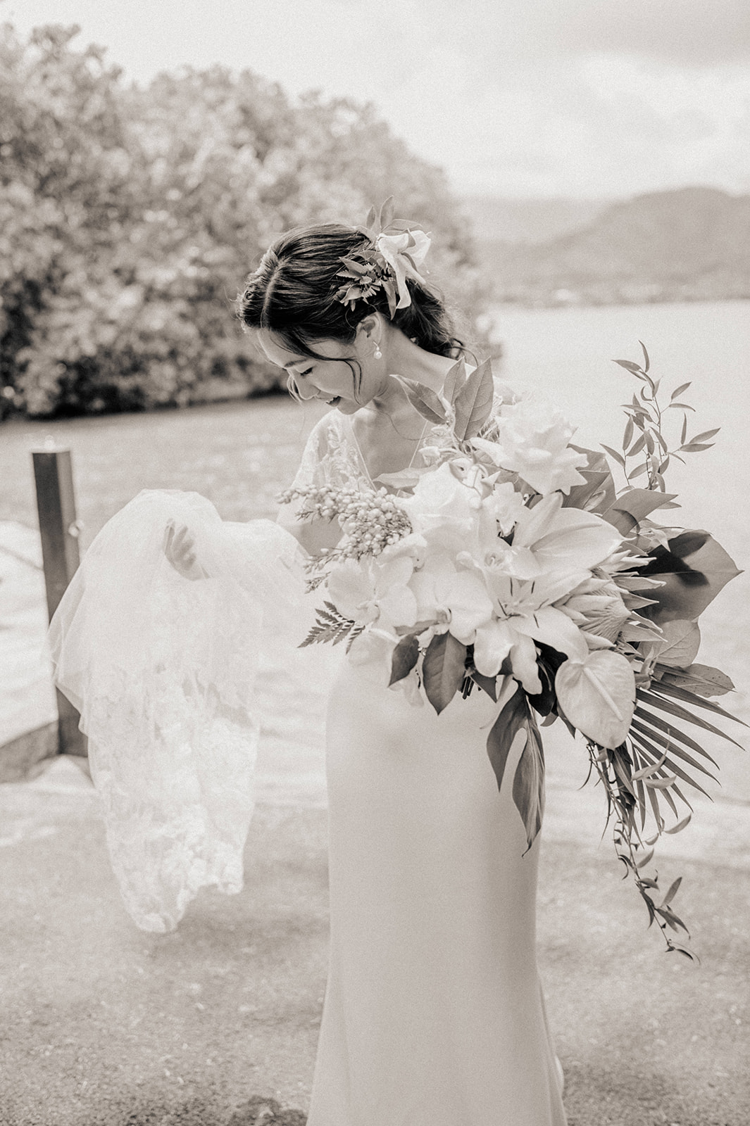 Black and white photo of bride with her gorgeous tropical wedding bouquet L Hewitt Photography