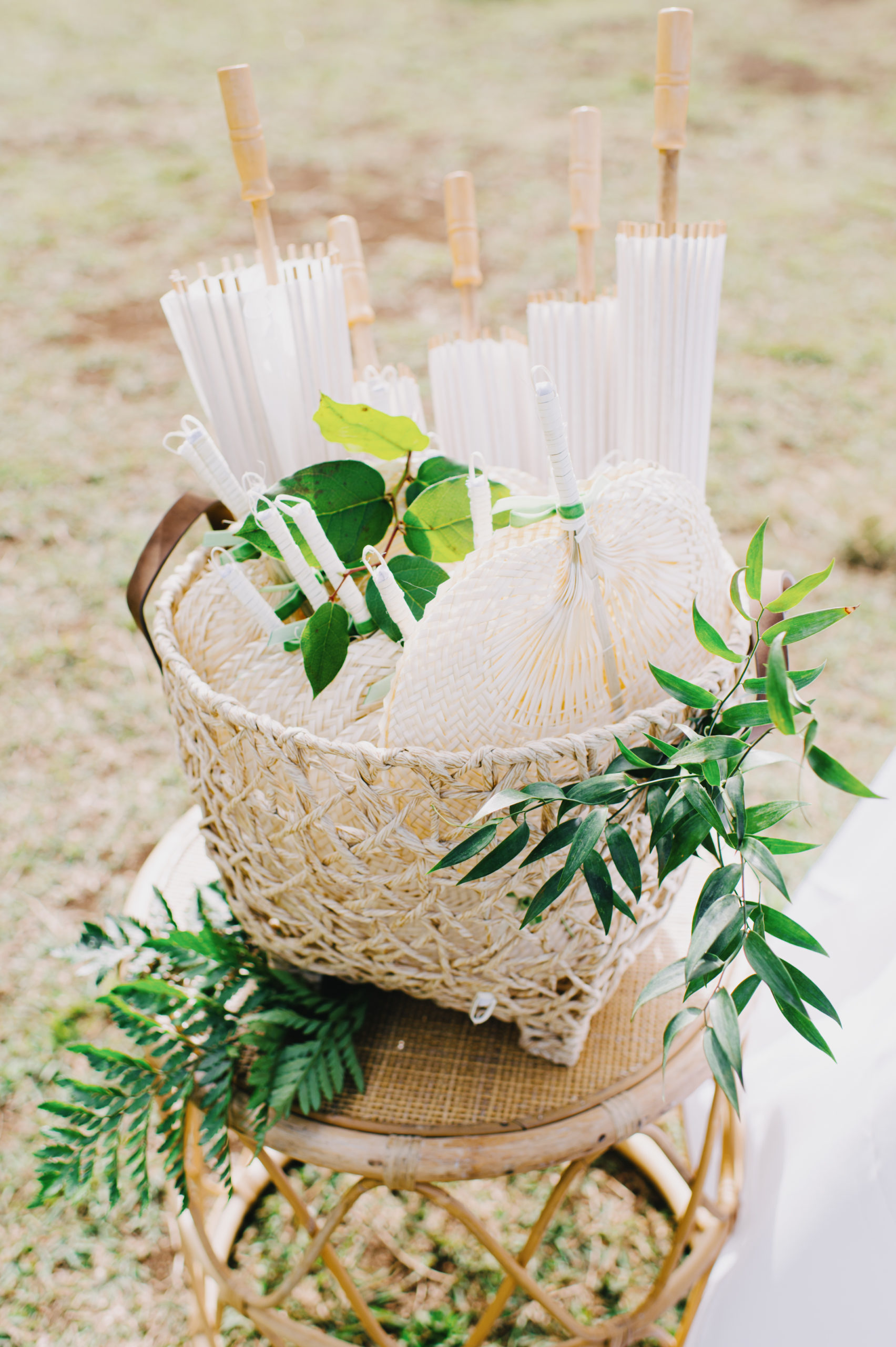 Stylish parasols and fans adding a touch of elegance to the tropical wedding atmosphere L Hewitt Photography