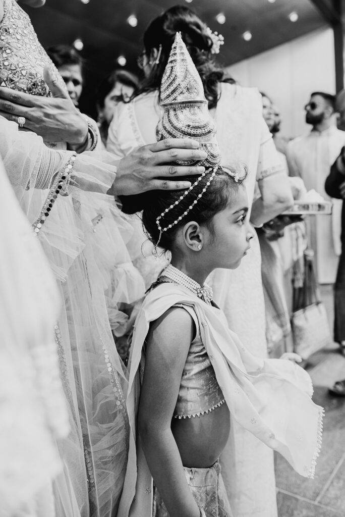 cute little girl enjoying the Indian wedding ceremony at Capital One Hall. L Hewitt Photography