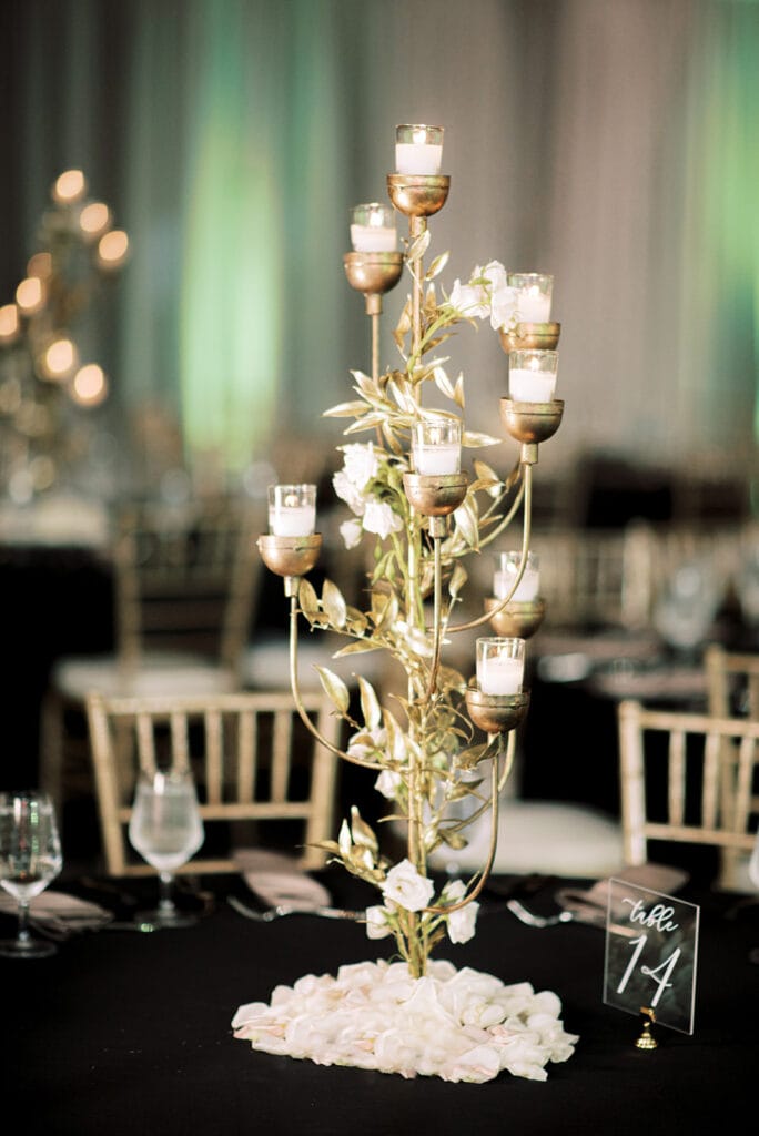 Elegant gold candelabra table centerpiece for an Indian wedding reception designed by S W Events at Capital One Hall. L Hewitt Photography